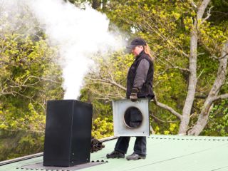 Professional chimney cleaner performing thorough maintenance.